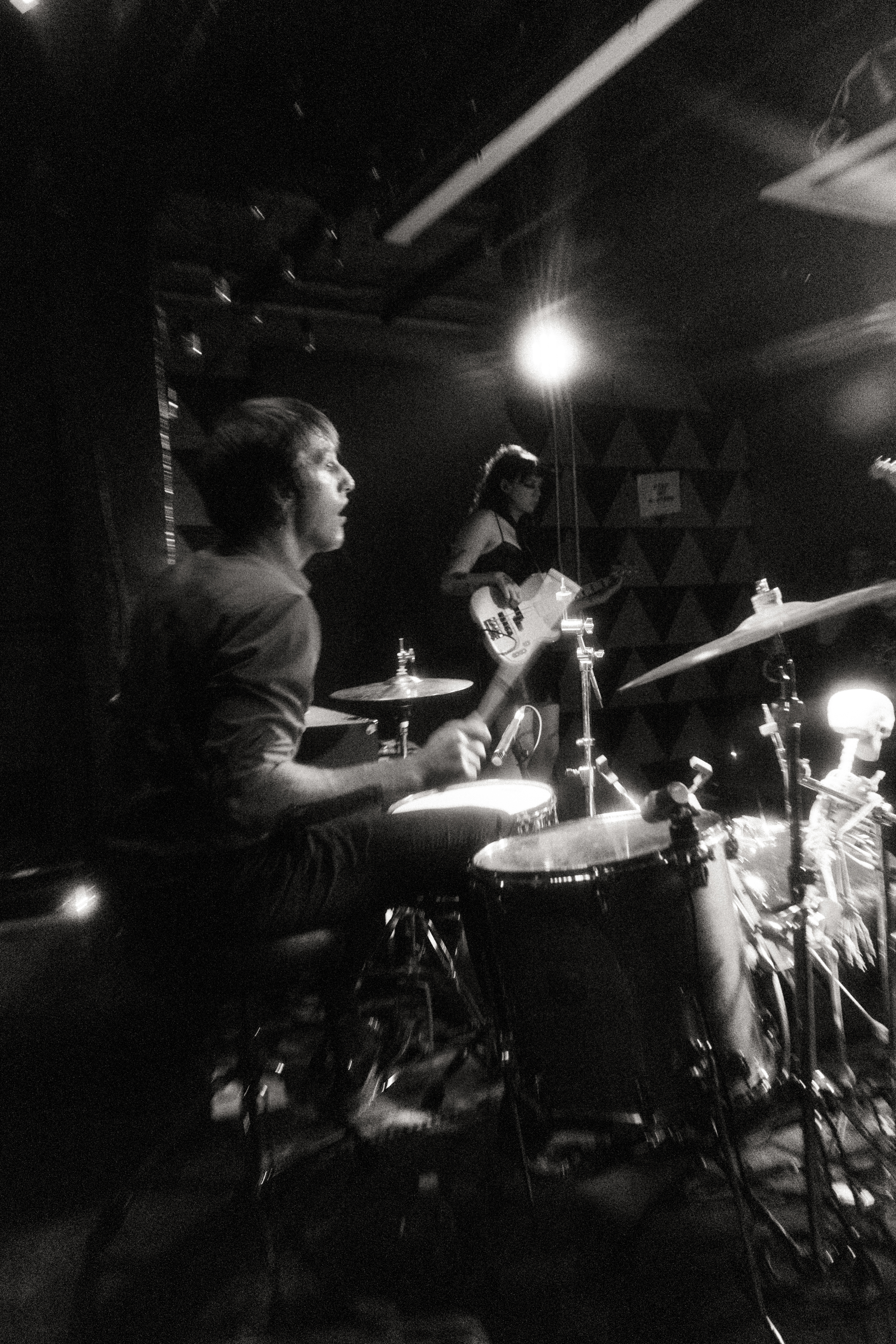 Etiquette drummer and bassist during a performance